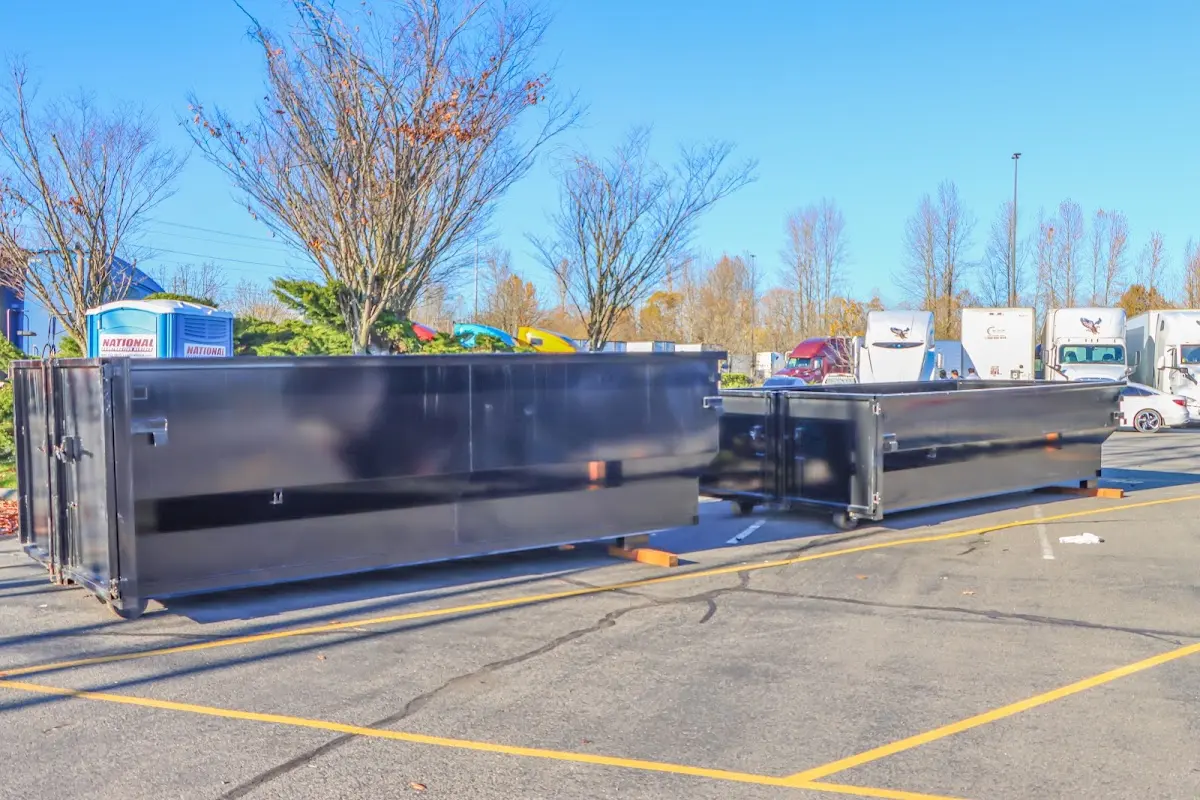 Professional dumpster rental service with roll-off container on residential driveway in Wallington